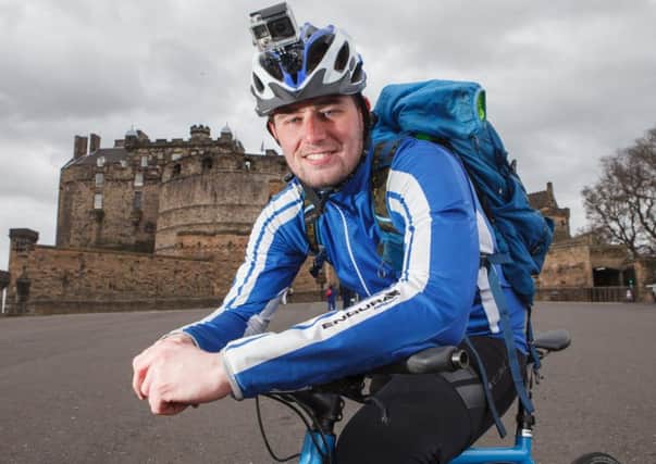 Josh Quigley completes his 1500-mile cycle challenge at Edinburgh Castle. Picture: Toby Williams