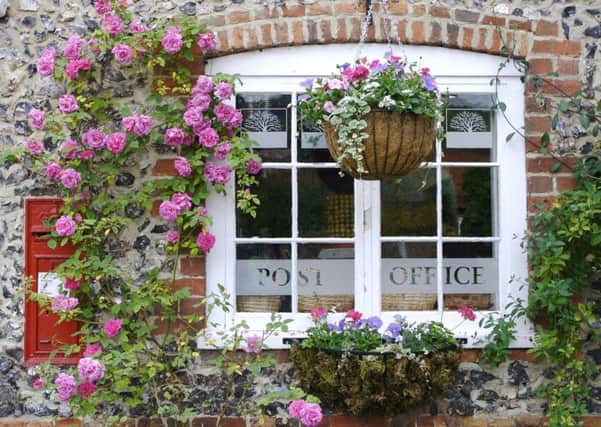 Hanging baskets on the exterior of a post office. Photo: PA Photo/thinkstockphotos.
