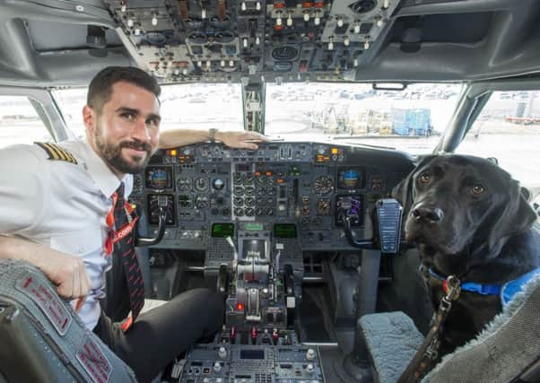 A Jet2 pilot gives one pup a tour of the cockpit. Picture: Lesley Martin