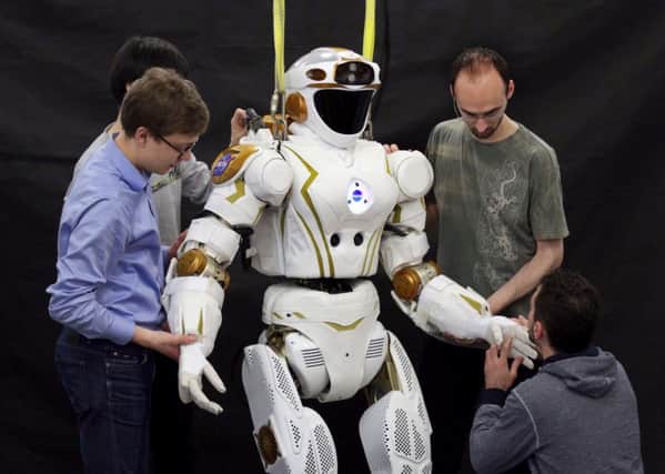 University of Edinburgh PhD students and researchers working on NASA's Valkyrie robot in the University of Edinburgh's School of Informatics. Picture: PA