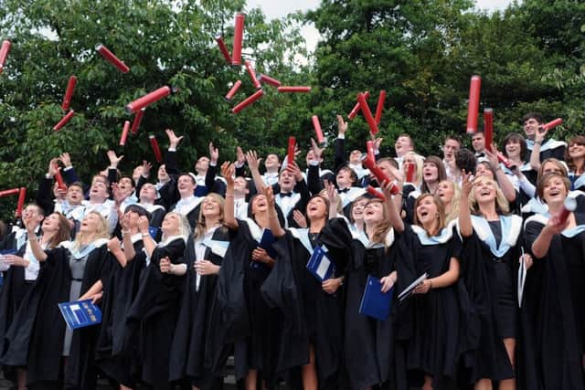 Graduates from the University of Edinburgh throw their scolls in the air after graduating. Picture: Ian Rutherford