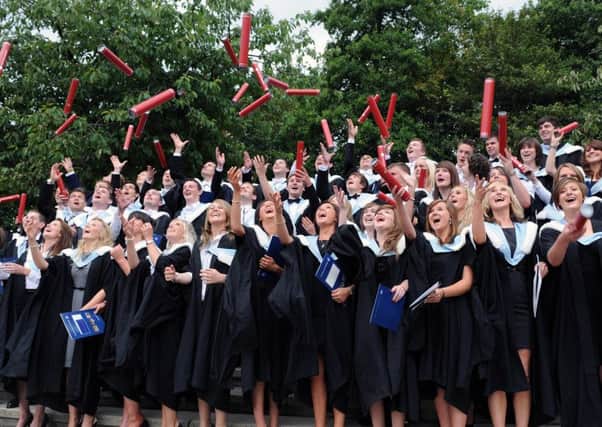 Graduates from the University of Edinburgh throw their scolls in the air after graduating. Picture: Ian Rutherford