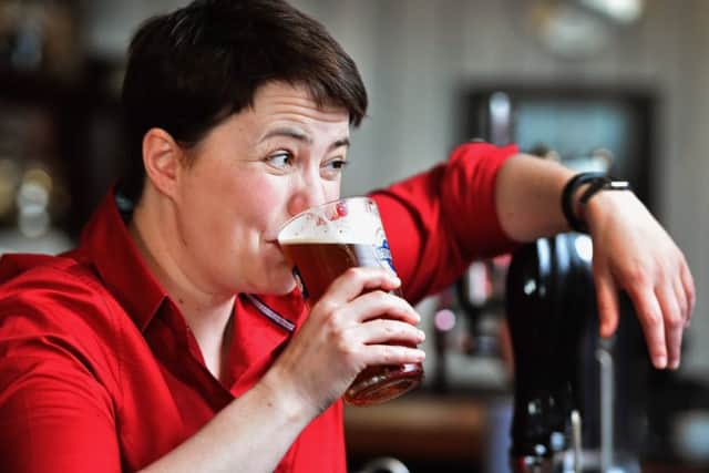 Ruth Davidson poses with a pint behind the bar during a visit to Raeburn Bar
