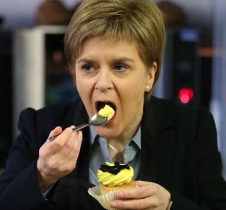 First Minister Nicola Sturgeon tries a cup cake during a campaign visit to Mimi's Bakehouse in Edinburgh, Scotland.