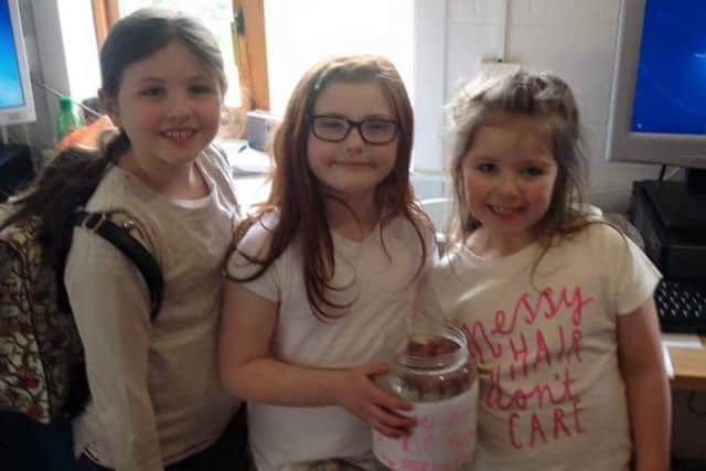 Jessica, seven, Belle, seven, and Zoey, eight have been fundraising at the school gates every morning for Gorgie farm. Picture: contributed