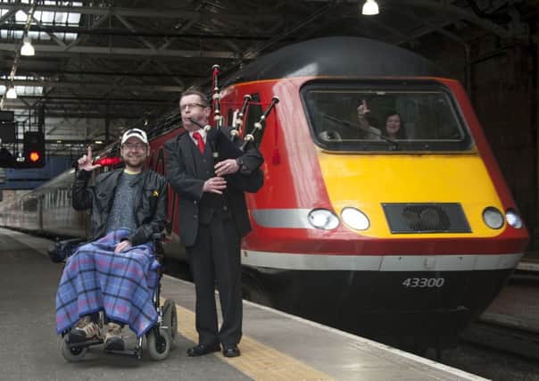 Lewis Vaughan with piper David Johnston as the train with #LForLewis arrives at Waverley Station. Picture: Andrew O'Brien