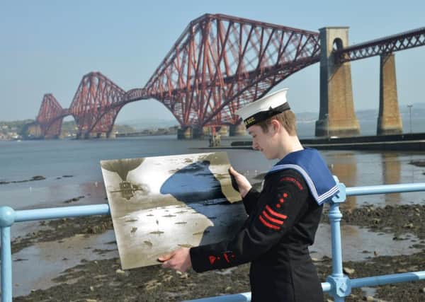 Murray George, 15, from South Queensferry Sea Cadets looks at a photo of the British Grand Fleet at anchor in the Firth of Forth in 1916.
 Picture: Jon Savage