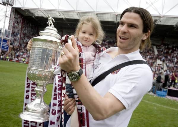 Julien Brellier, bottom right, gets his hands on the Scottish Cup back in 2006. Pic: SNS