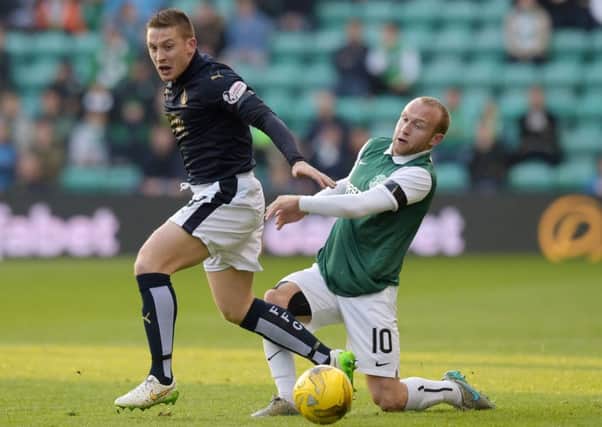 Dylan McGeouch battles for the ball with Falkirks John Baird. McGeouch insists Hibs have the squad to win at Westfield