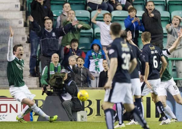 Hibs players - and fans - call for a penalty after David McCracken's handball. Pic: SNS