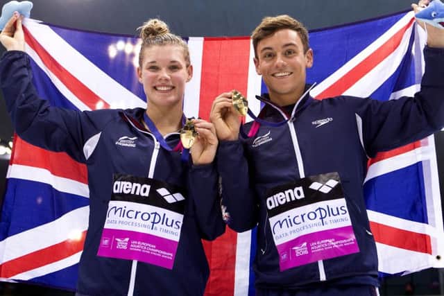 Grace Reid and Tom Daley show off their medal. Pic: Getty