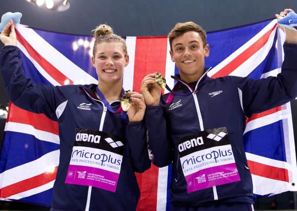 Grace Reid and Tom Daley show off their medal. Pic: Getty