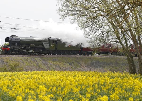 The Flying Scotsman passes a rapeseed field near Durham, as part of its UK tour. Picture: PA
