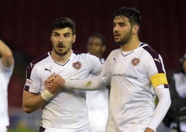 Callum Paterson and Alim Ozturk shake hands as the 
players thank the sizeable Hearts support who travelled north to Aberdeen