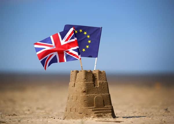 In this photo illustration the flag of the European Union and the Union flag sit on top of a sand castle on a beach on May 09, 2016 in Southport, United Kingdom. Picture: Getty Images