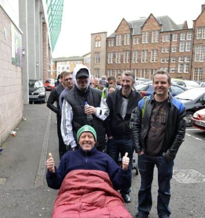 Registered Hibs supporters pass the time while queuing for Scottish Cup final tickets. Picture: Julie Bull