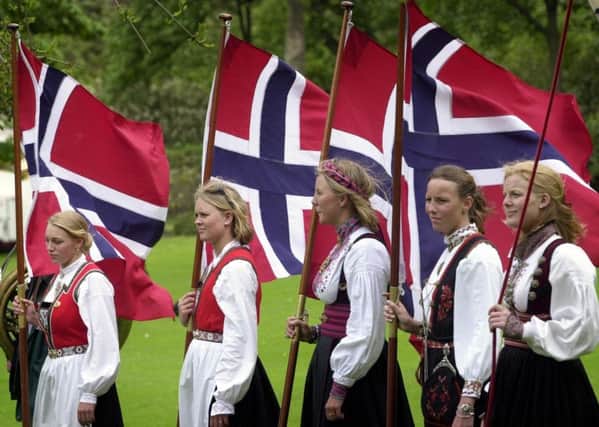 Flag carrying Norwegian girls in  Princes street Gardens on  Norway day.