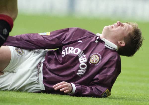Gary Locke writhes in agony after injuring his knee minutes into the Scottish Cup final against Rangers in 1996. Pic: SNS