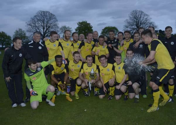 Edinburgh Citys players pose with the trophy at Whitehill Welfare. Pic: Andrew O'Brien