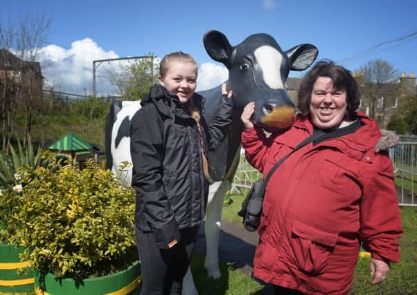 Tyler Paget, 14, and Moira Black volunteer at Gorgie City Farm. Picture: Jane Barlow