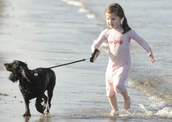 Martha O'Hanlon with her dog, Maggie, at Portobello beach. Picture: Phil Wilkinson