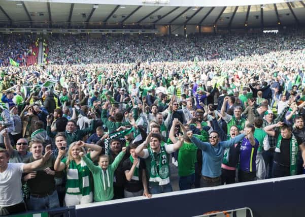 Hibernian fans celebrate on pitch after their historic win. Picture: Jeff Holmes/PA Wire.