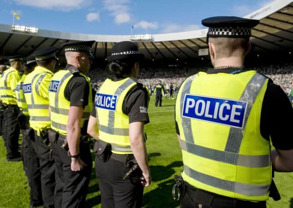 Police line the Hampden pitch
