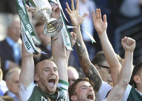 Hibs' David Gray lifts the Scottish Cup. Picture: Neil Hanna