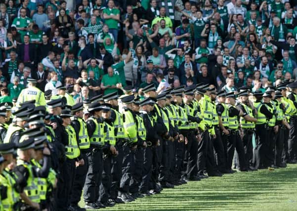 Police on the field at Hampden. Picture: Robert Perry