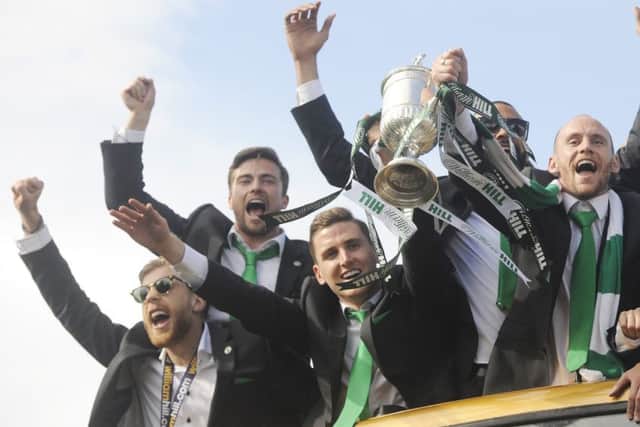 Niklas Gunnarsson, bottom, left enjoys the Hibs cup parade. Pic: Greg Macvean