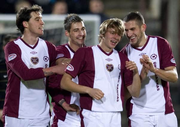 Pick of the bunch: Arvydas Novikovas, second right, is congratulated after scoring Hearts fifth goal of the game