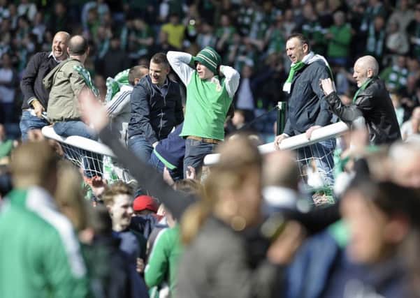 Hibs fans on the crossbar after the Scottish Cup final win. Picture: Neil Hanna