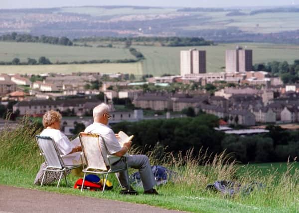 A retired couple enjoy the sunshine on Arthur's Seat. File picture: Jon Savage