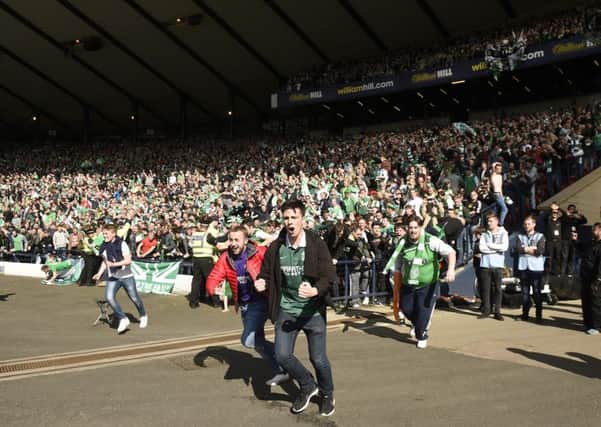 Greg Binnie was among the Hibs fans who invaded the pitch after the match. Picture: Greg Macvean