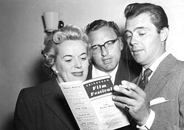 Film producer Betty Box, director Ralph Thomas and actor Dirk Bogarde read the programme for the 1955 Edinburgh Film Festival at the Film House in Hill Street