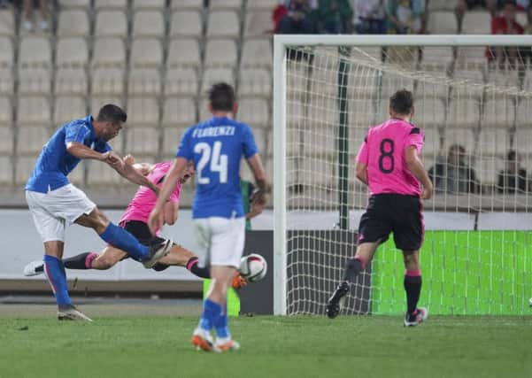 Italys Graziano Pelle lashes in the only goal of the game following a slip by Steven Fletcher