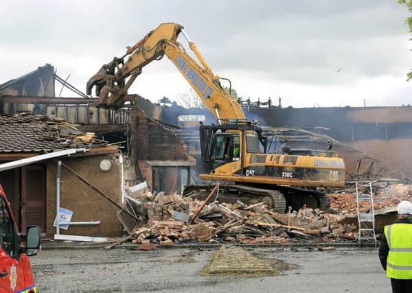 The original Hopefield Primary building is demolished after being gutted by fire in May 2015.