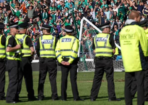 Police restore order after unrest at Hampden Park. Picture: Robert Perry