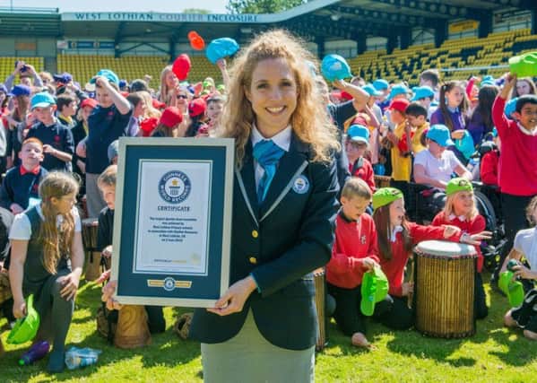 Guinness World Record adjudicator Anna Orford presents the certificate. Picture: Ian Georgeson