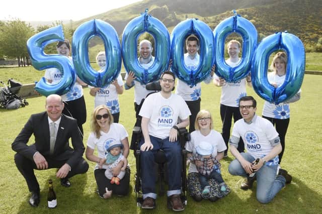 Gordon Aikman celebrates raising Â£500,000 for MND with Gordon's Fightback team, campaigners (including Kezia Dugdale) and family in Holyrood Park. Picture: Greg Macvean
