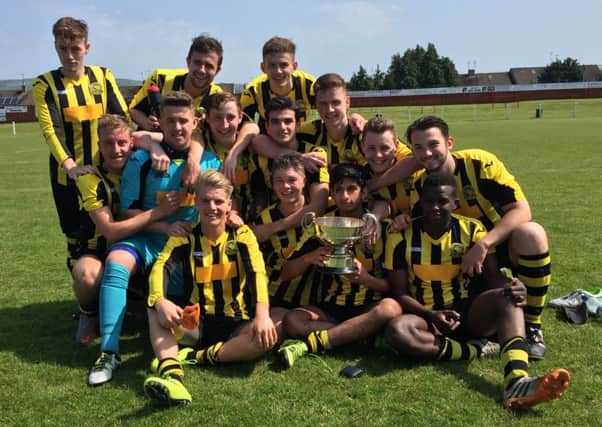 Hutchison Vale 19s show off the Cruden Bowl after their 8-3 victory over Spartans