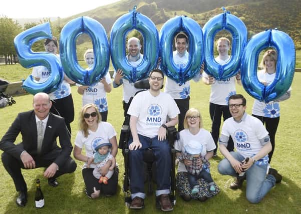 Gordon Aikman celebrates raising Â£500,000 for MND with Gordon's Fightback team, campaigners (including Kezia Dugdale) and family in Holyrood Park. Picture: Greg Macvean