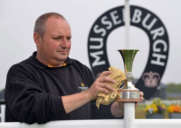 Head groundsman Mark Bemrose polishes the Scottish Sprint Cup as preparations continue for Musselburghs richest-ever meeting this Saturday. The Â£100,000 sprint will be the main race on Ladies Day card. Pic: Jon Savage