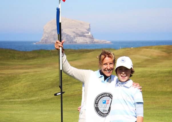 French golfer Augustin Valery, 12, celebrates his albatross with Bass Rock in the distance