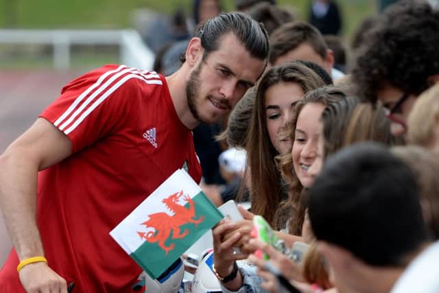 Welsh icon Gareth Bale poses for a selfie with young fans as the squad trains for their first Euro2016 match on Saturday. Picture: contributed