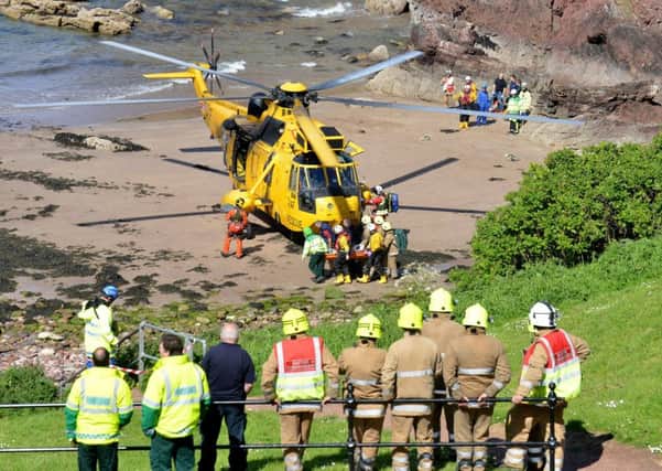 Rescue services at the scene of a cliff fall in Dunbar. Picture: Jon Savage