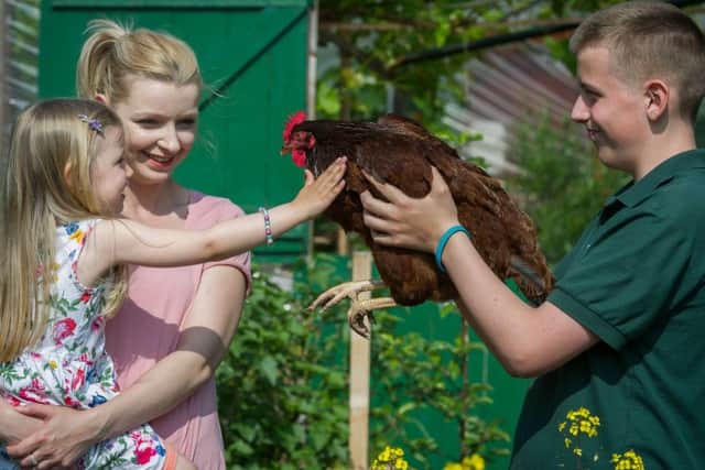 Dina and Rosie Sedgwick, four, with volunteer Steven P Hogan. Picture: Scott Taylor