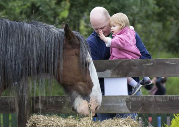 Michael Mikalauskas with daughter Abagail at Gorgie City Farm. File picture: Malcolm McCurrach