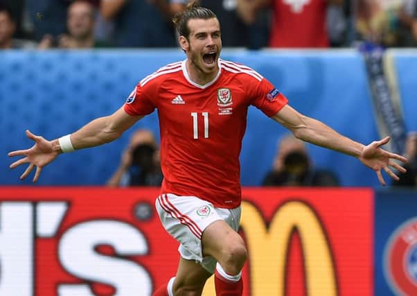 Gareth Bale celebrates after his stunning free kick against Slovakia put his team on the road to three vital points