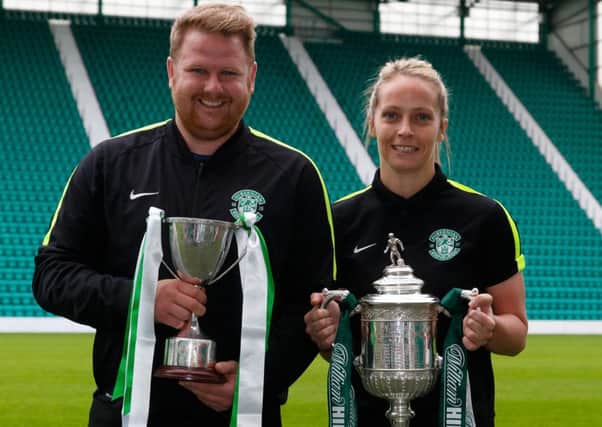 Hibs Ladies team manager Chris Roberts and centre half Joelle Murray holding the Ladies League cup and the Scottish Cup respectively. Picture: Scott Louden